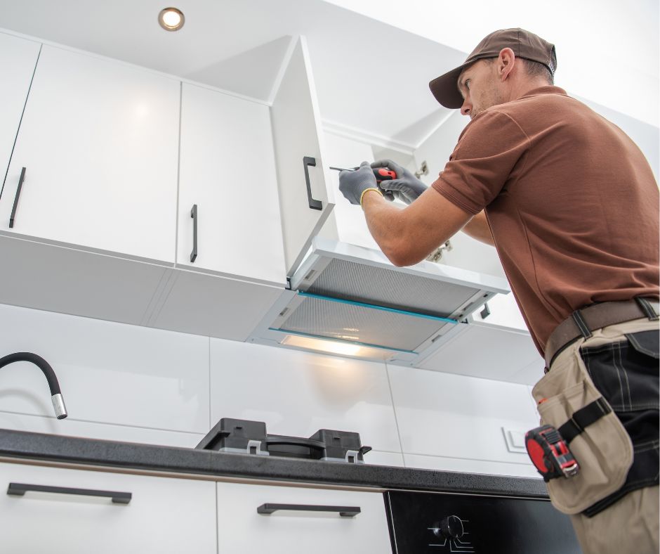 Contractor repairing a kitchen cabinet door handle